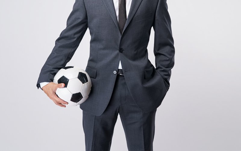 Hombre de traje con pelota en la mano